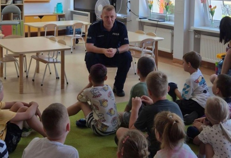 Spotkanie przedszkolaków z policjantami – bezpieczne wakacje pod okiem stróżów prawa.